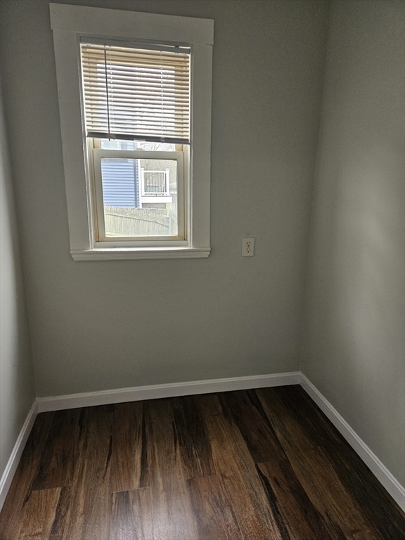 21 Baldwin Street, Unit 1 Malden, MA 02148 - Photo 5 of 19 a view of an empty room with wooden floor and a window