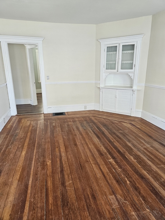 21 Baldwin Street, Unit 1 Malden, MA 02148 - Photo 7 of 19 a view of an empty room with wooden floor and a window