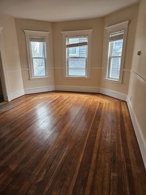 21 Baldwin Street, Unit 1 Malden, MA 02148 - Photo 8 of 19 a view of an empty room with wooden floor and window