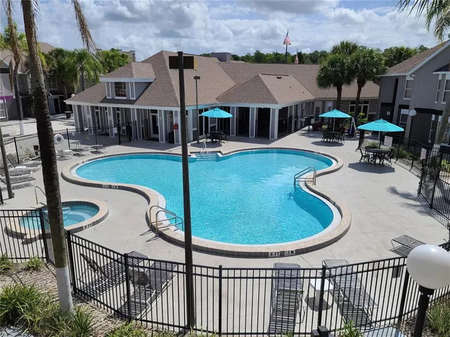 swimming pool view with a seating space