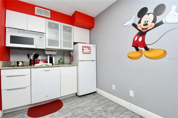 a kitchen with stainless steel appliances granite countertop a sink a stove and cabinets