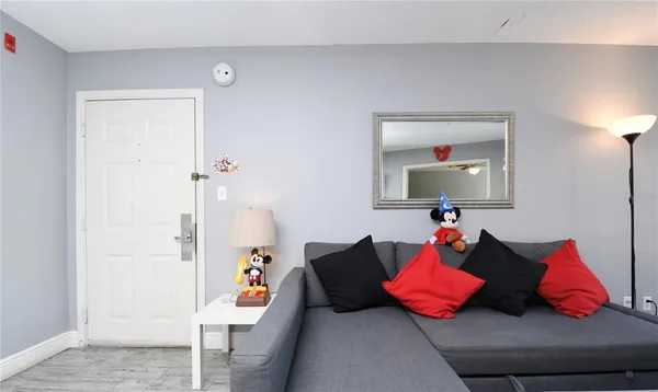 a living room with furniture and a lamp