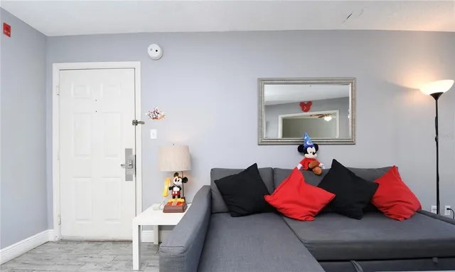 a living room with furniture and a lamp