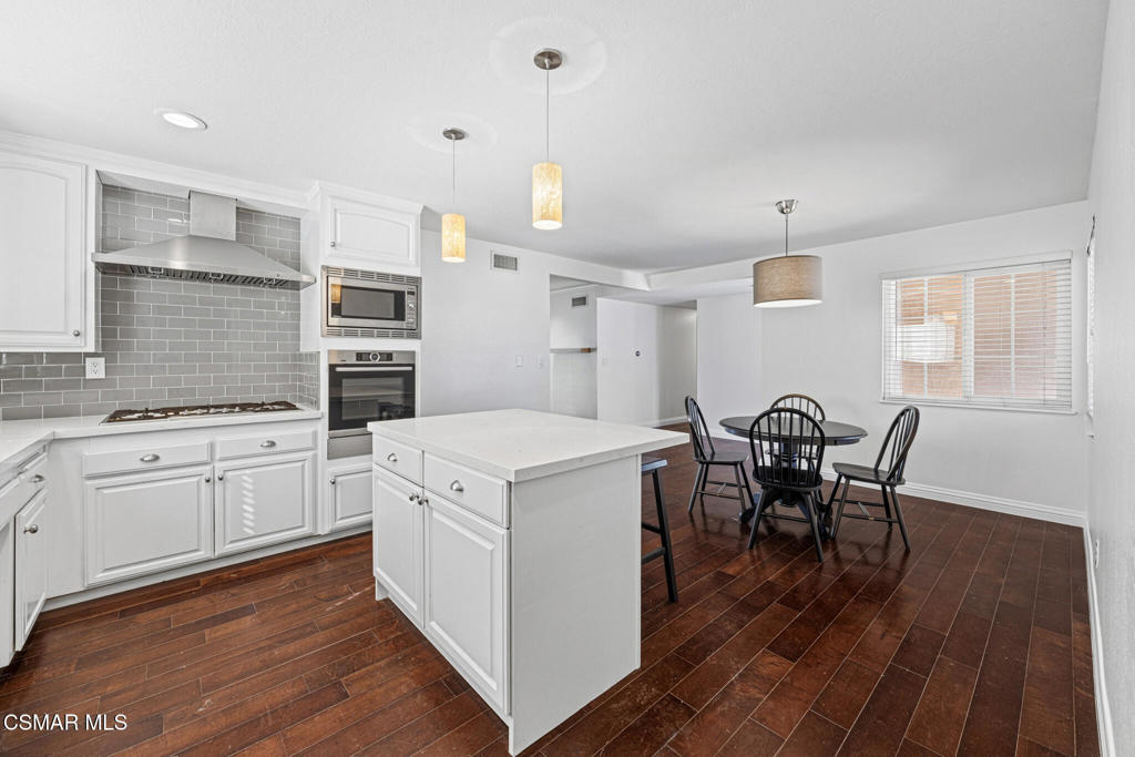 1521 Church Street Simi Valley, CA 93065 - Photo 4 of 16 a kitchen that has a cabinets counter space dining table and a sink
