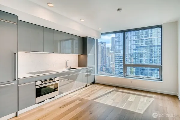 a kitchen with stainless steel appliances a stove top oven and a refrigerator