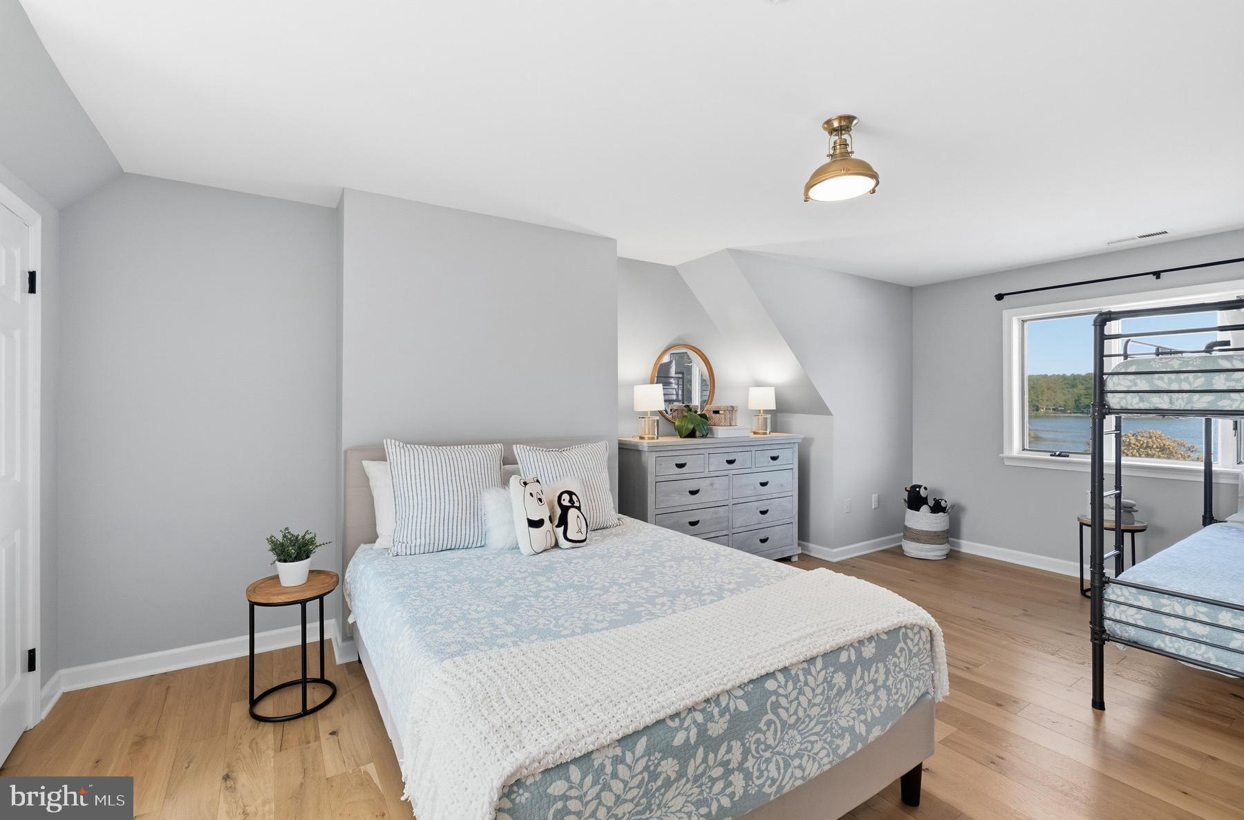 25500 Chance Farm Road St. Michaels, MD 21663 - Photo 28 of 43 a bedroom with a bed and wooden floor