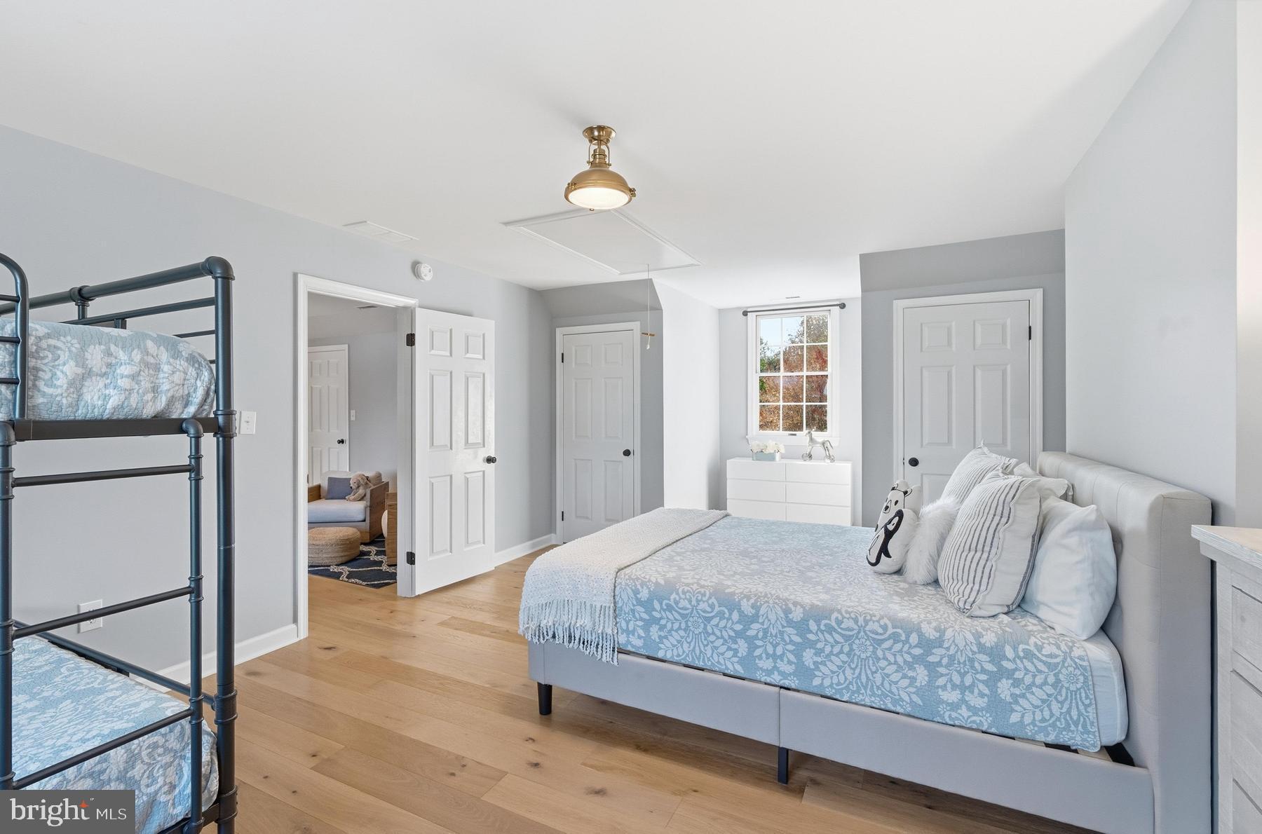 25500 Chance Farm Road St. Michaels, MD 21663 - Photo 29 of 43 a bedroom with a bed and a chandelier