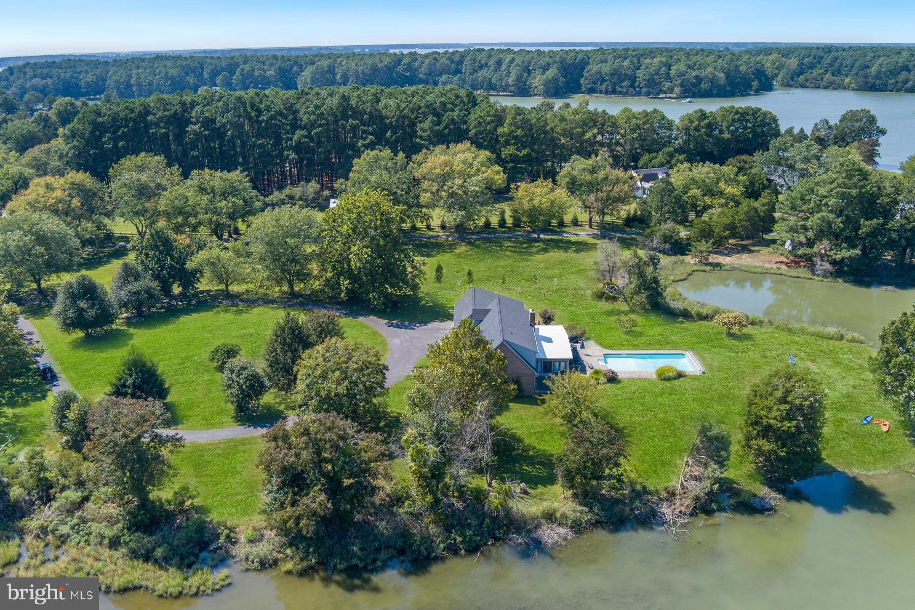 25500 Chance Farm Road St. Michaels, MD 21663 - Photo 40 of 43 an aerial view of green landscape with trees houses and lake view