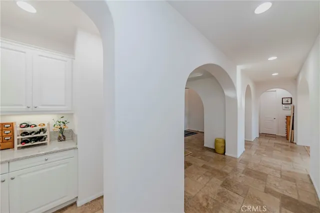 a kitchen with a refrigerator and white cabinets