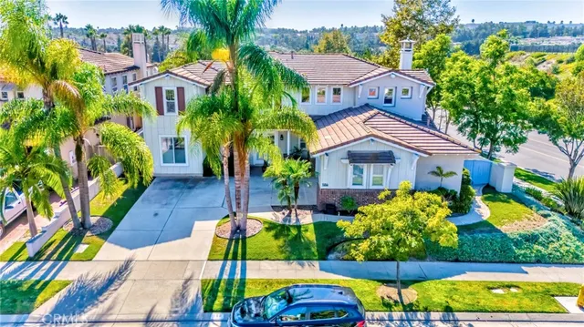 a view of house with swimming pool lawn chairs and flower plants