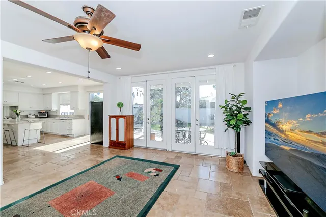 a view of a hallway with entryway wooden floor stairs and a chandelier