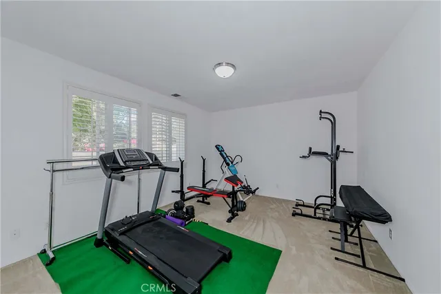 a living room with furniture a flat screen tv and a window