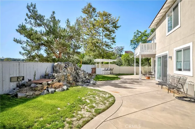 a view of a house with a yard and garden