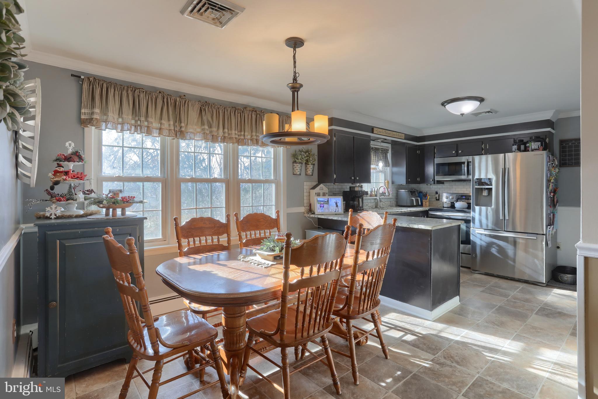 3032 Tunnel Hill Road Lebanon, PA 17046 - Photo 7 of 52 a dining room with furniture a chandelier and kitchen view