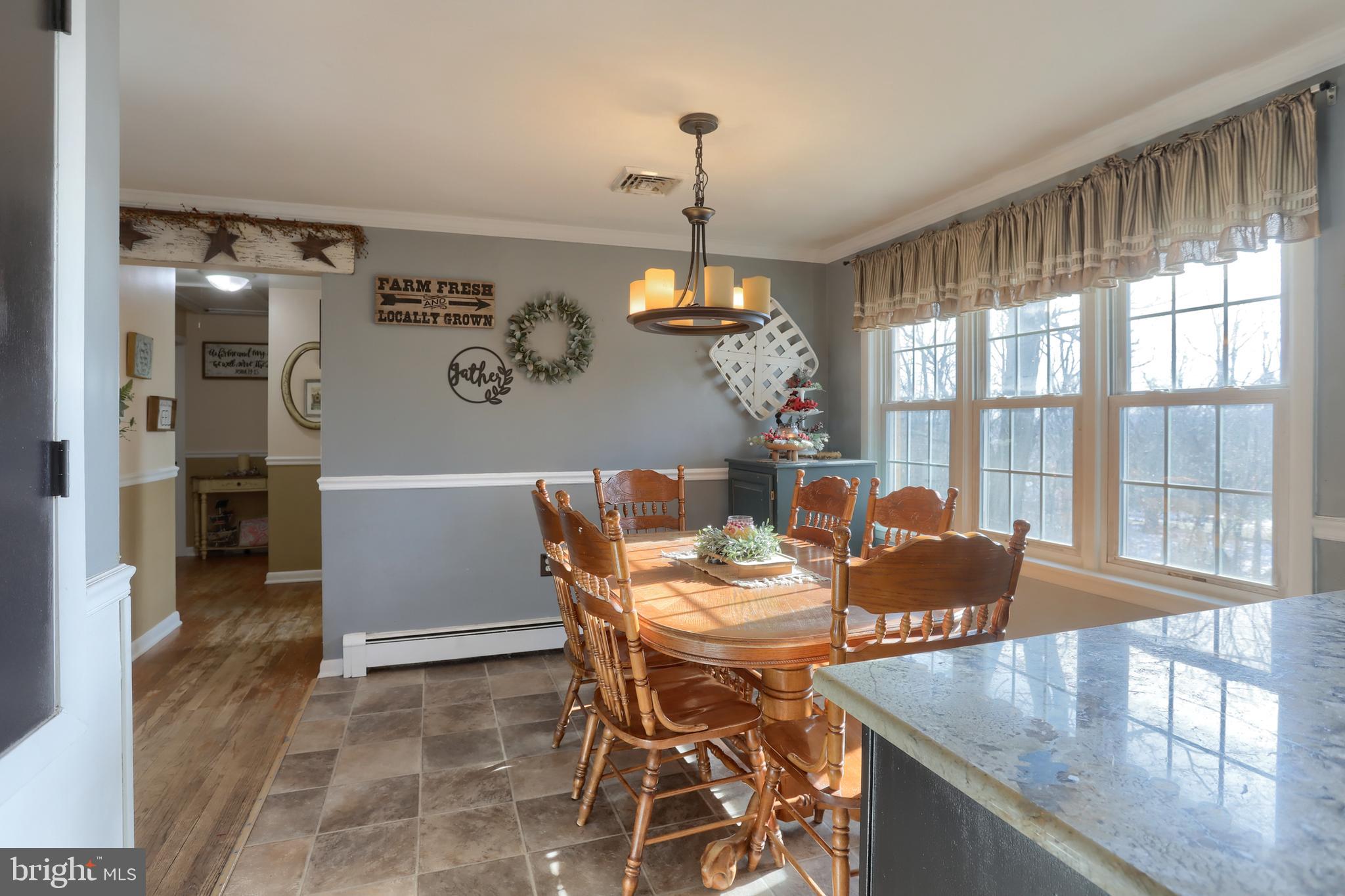 3032 Tunnel Hill Road Lebanon, PA 17046 - Photo 8 of 52 a dining room with furniture a chandelier and wooden floor