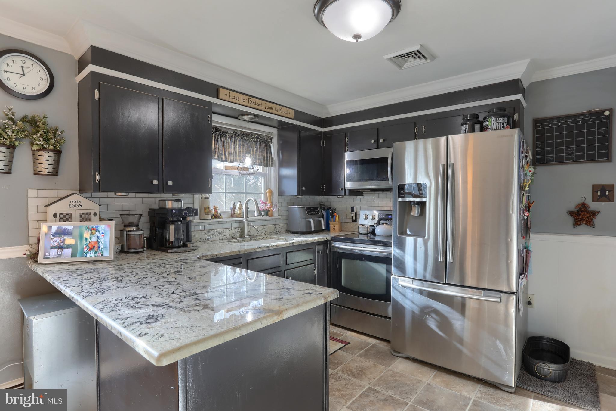 3032 Tunnel Hill Road Lebanon, PA 17046 - Photo 9 of 52 a kitchen with granite countertop stainless steel appliances a sink stove and refrigerator