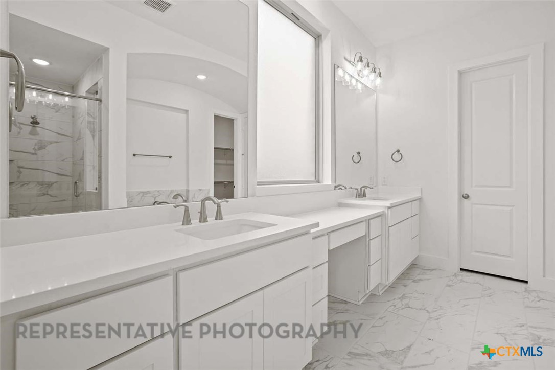 129 Ribera Drive Liberty Hill, TX 78642 - Photo 10 of 23 a bathroom with a double vanity sink mirror and double