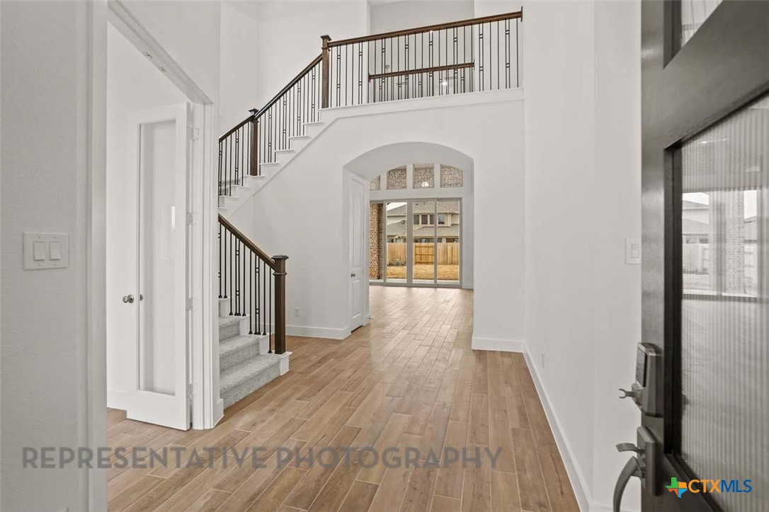129 Ribera Drive Liberty Hill, TX 78642 - Photo 14 of 23 a view of entryway and hall with wooden floor