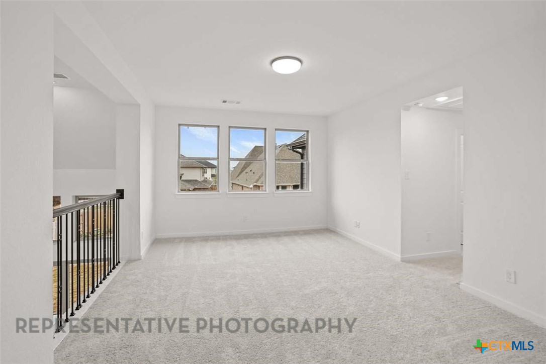 129 Ribera Drive Liberty Hill, TX 78642 - Photo 17 of 23 an empty room with windows