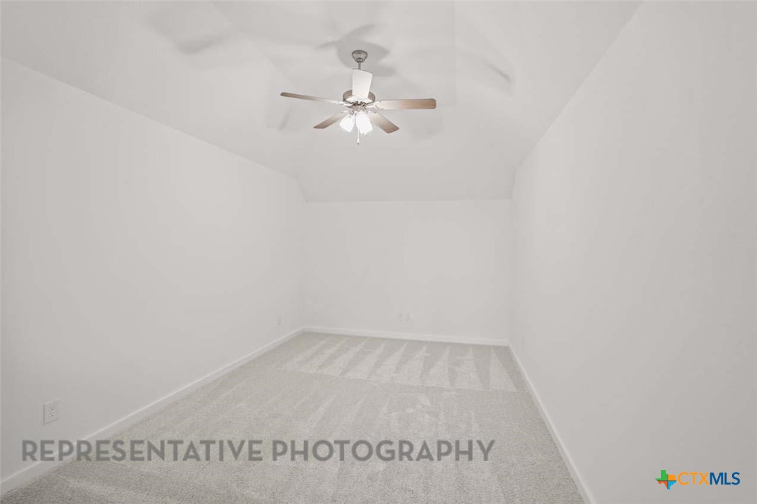 129 Ribera Drive Liberty Hill, TX 78642 - Photo 18 of 23 a view of a room with wooden floor and fan