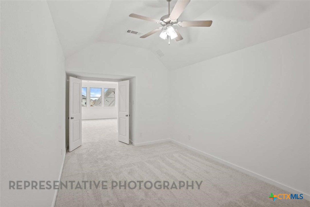 129 Ribera Drive Liberty Hill, TX 78642 - Photo 19 of 23 an empty room with windows and fan