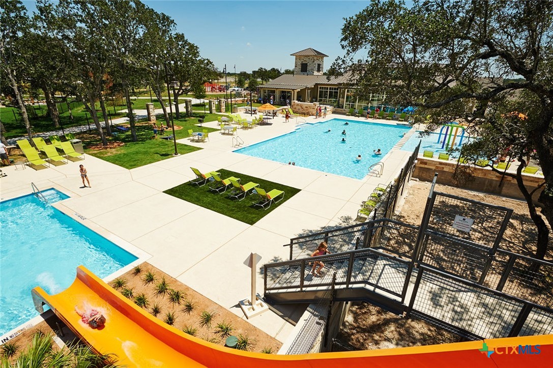 129 Ribera Drive Liberty Hill, TX 78642 - Photo 22 of 23 a view of a swimming pool with a patio and a yard