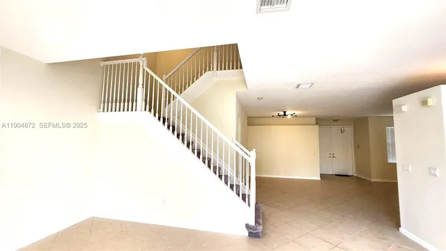 a bedroom with a large bed and a potted plant