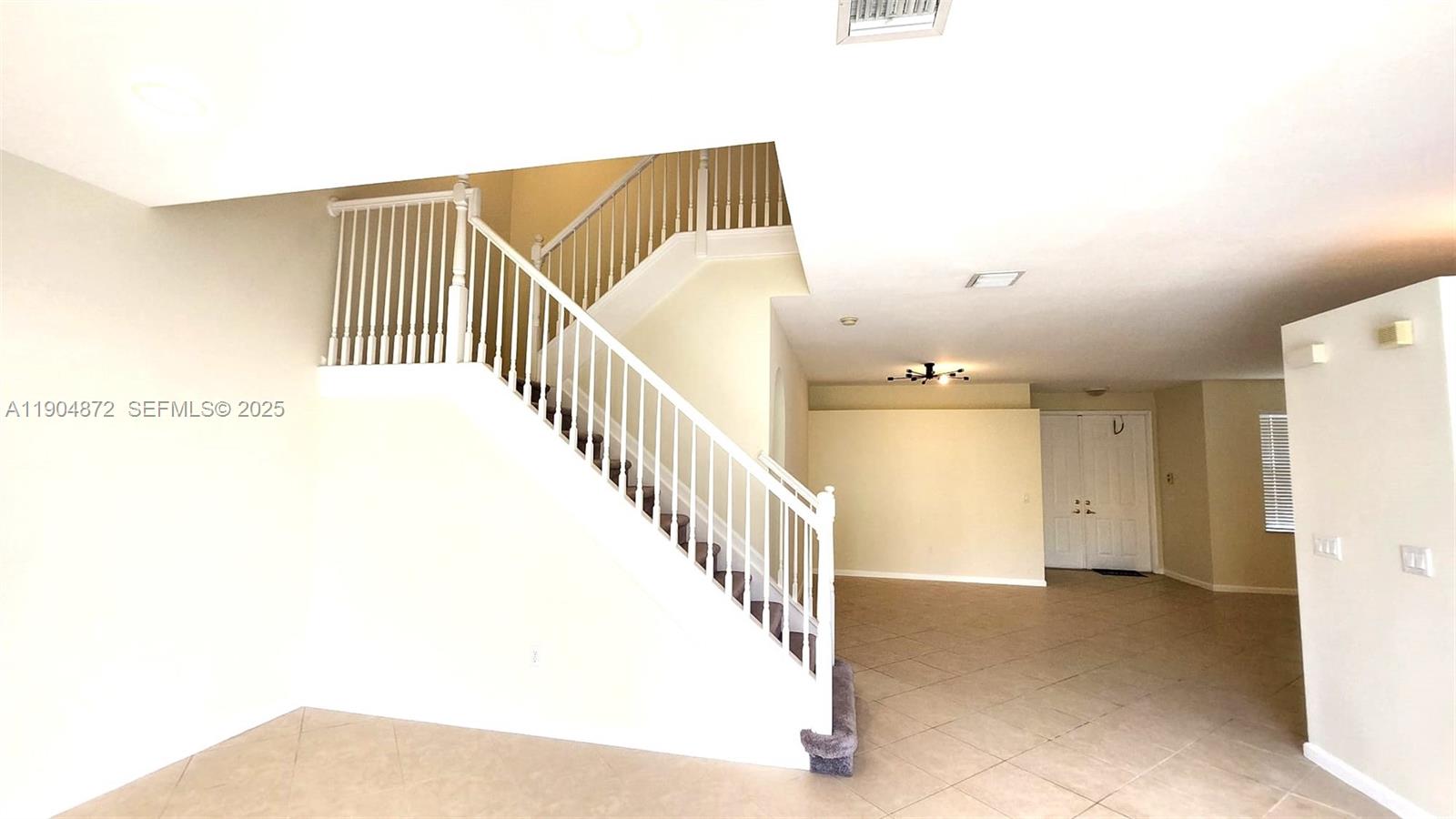 9042 Dupont Place Wellington, FL 33414 - Photo 12 of 43 a view of a hallway with staircase