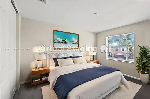 a bedroom with a large bed and a potted plant