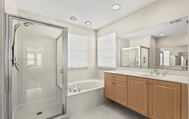 a bathroom with a double vanity sink a toilet and a mirror