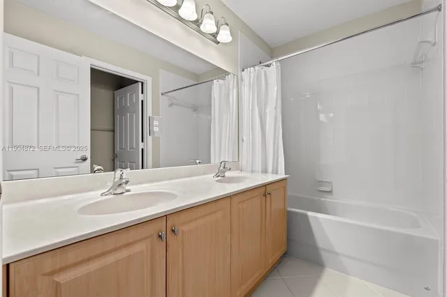 a bedroom with a bed mirror and window