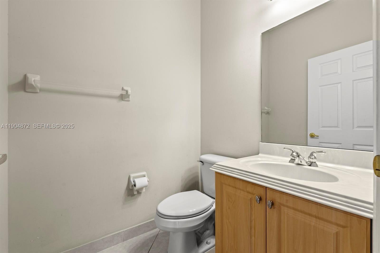 9042 Dupont Place Wellington, FL 33414 - Photo 22 of 43 a bathroom with a sink toilet and a mirror