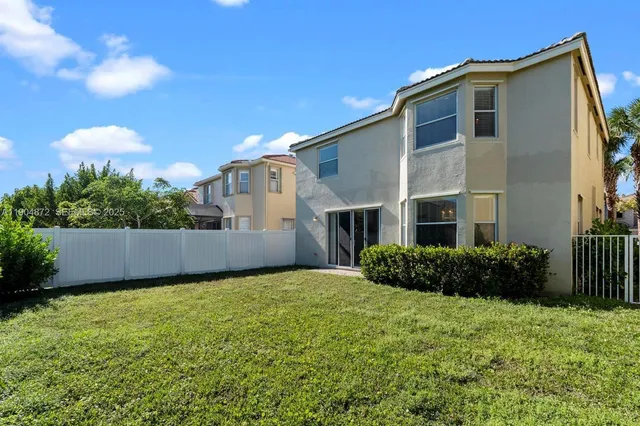 a view of a large garden with a house