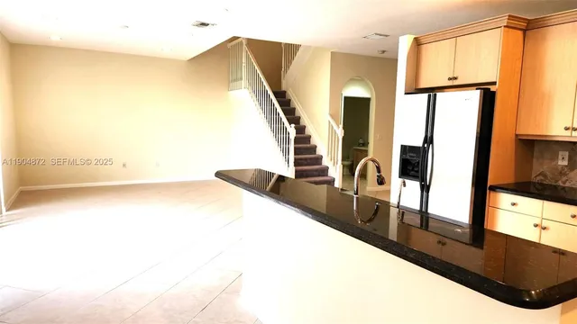 a view of a living room with kitchen