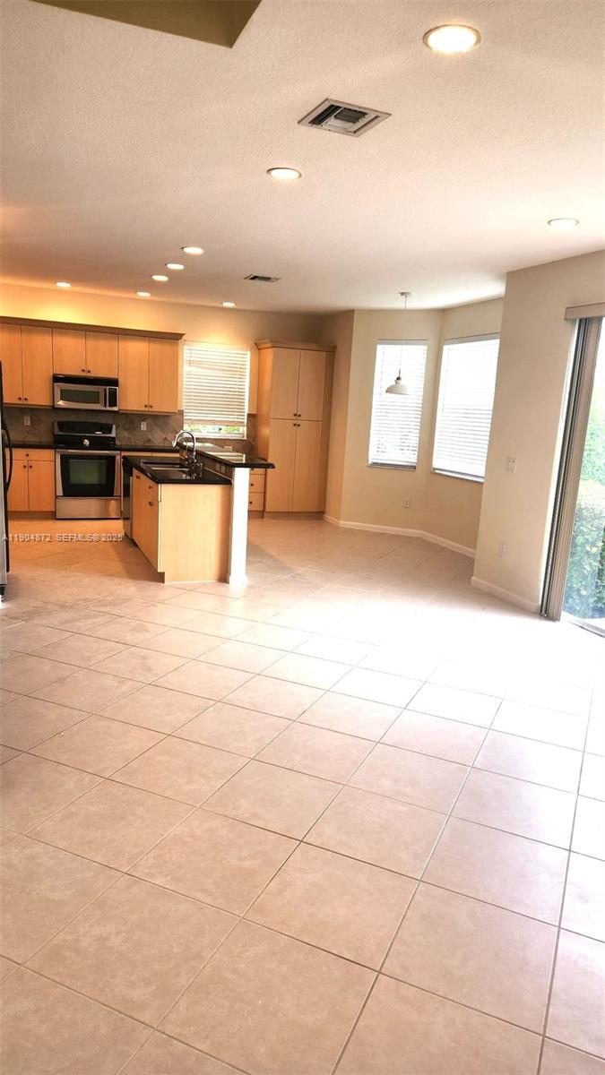 9042 Dupont Place Wellington, FL 33414 - Photo 10 of 43 a view of a living room with kitchen