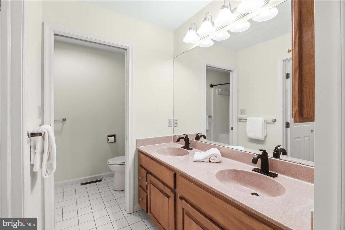 9 Parkside Drive Elverson, PA 19520 - Photo 13 of 33 a bathroom with a sink a toilet and a mirror