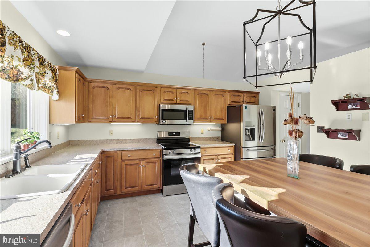 9 Parkside Drive Elverson, PA 19520 - Photo 5 of 33 a kitchen with stainless steel appliances kitchen island granite countertop a sink and cabinets