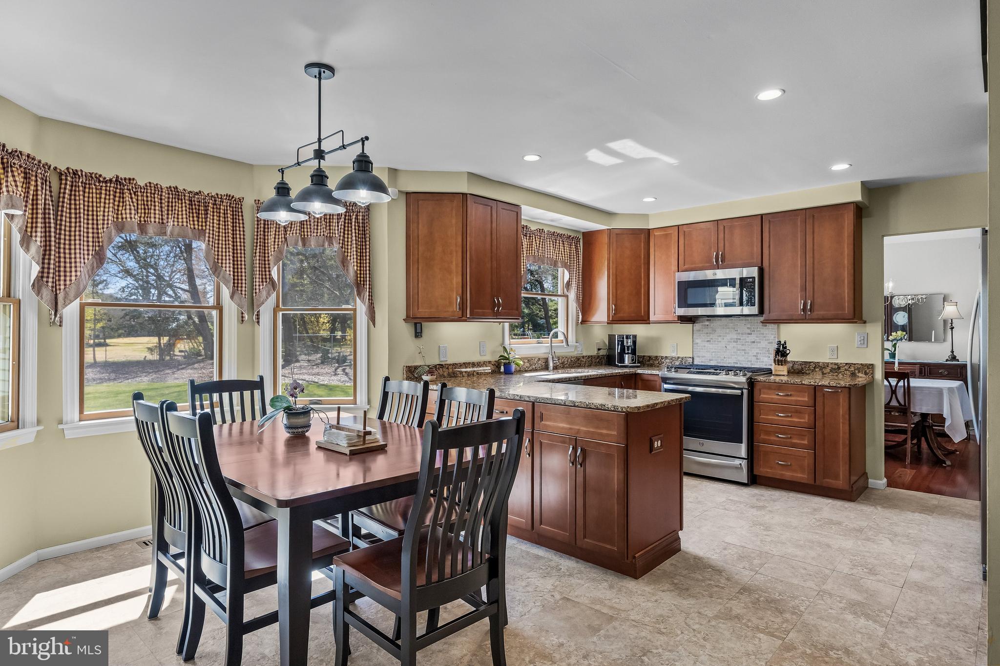 446 Prospect Avenue West Berlin, NJ 08091 - Photo 15 of 54 a kitchen with a dining table chairs and refrigerator