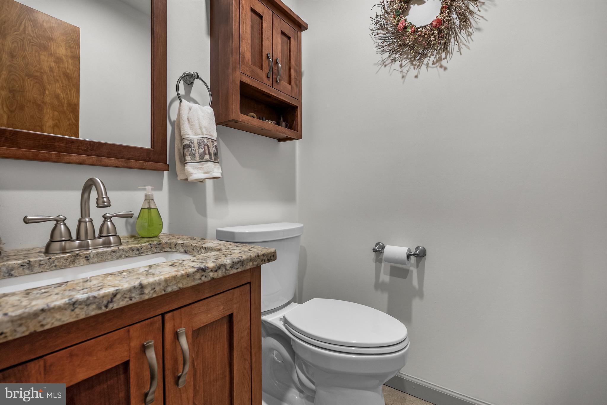 446 Prospect Avenue West Berlin, NJ 08091 - Photo 16 of 54 a bathroom with a granite countertop toilet sink and mirror