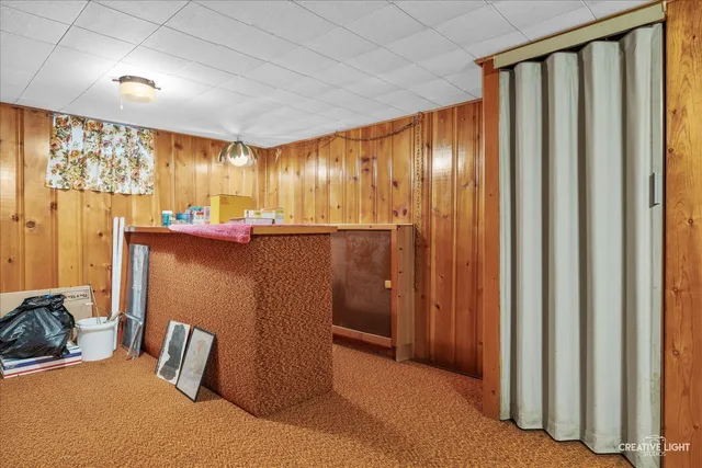 a view of a room with furniture and a window