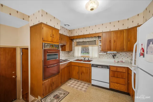 a kitchen with granite countertop a sink stainless steel appliances and cabinets