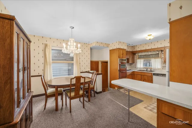 a large kitchen with a table and chairs