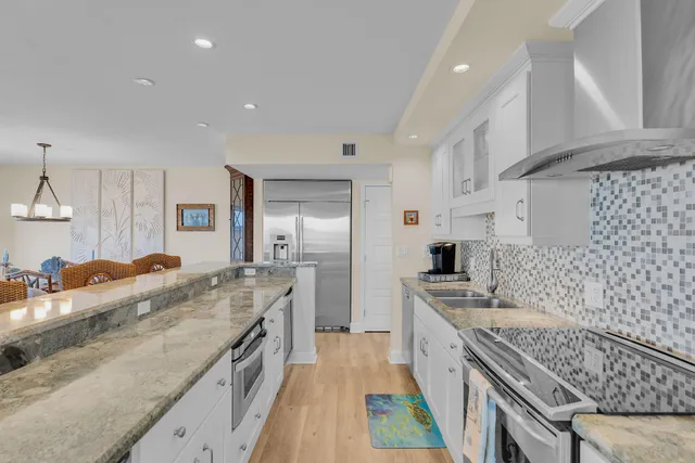 a living room with furniture and kitchen view