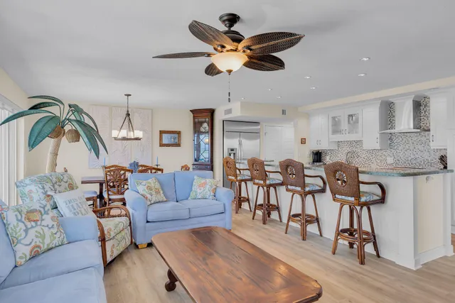 a bedroom with a bed dresser and a large window