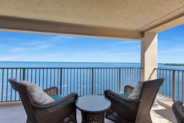 a balcony with table and chairs