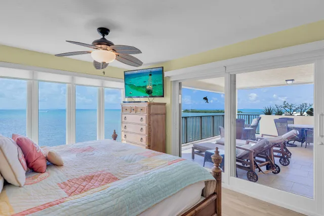 a bedroom with a bed and a large window