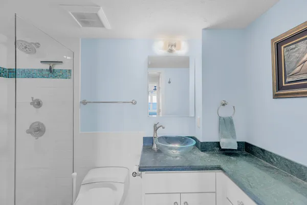a view of a hallway with wooden floor and windows