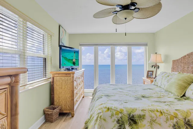 a bathroom with a tub shower sink and mirror