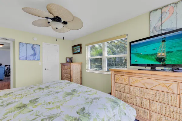 a bedroom with two beds and a chandelier