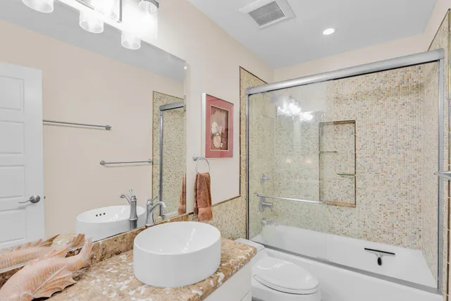 a bedroom with two beds and a chandelier